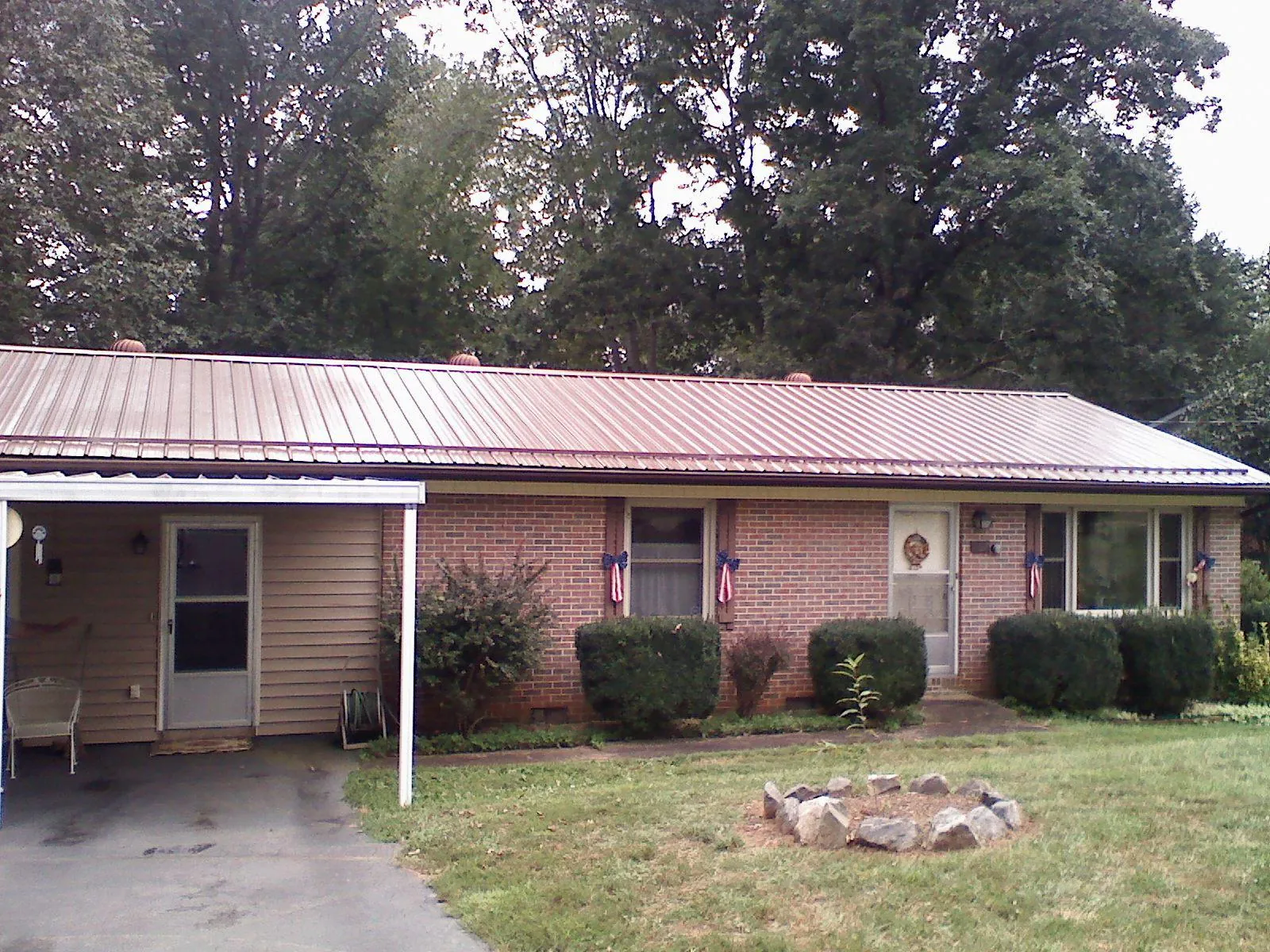 Bronze metal roof and carport on a brick ranch home — Roof Repair work by our crew in Richfield